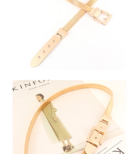 Detailed view of elastic metal waist belt with square buckle over Kinfolk magazine