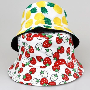 Reversible bucket hat featuring pineapple and strawberry tropical fruit print designs