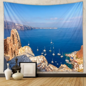 Detail of Santorini landscape tapestry with blue sea and sailboats on grey wall