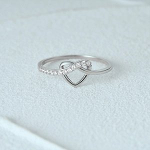 Close-up of S925 sterling silver heart-shaped ring with pavé diamond accents