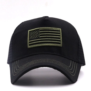 Close-up of olive green American flag embroidery on a black mesh trucker baseball cap