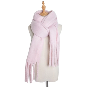 Detail of pink knitted mohair scarf featuring long tassels on a professional mannequin