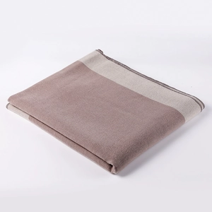 Detail of two-tone pink and brown shawl with beige stitched edges and soft knit texture