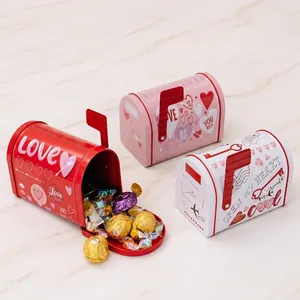 Close-up of heart-themed tin mailbox gift boxes in red, pink, and white for Valentine's