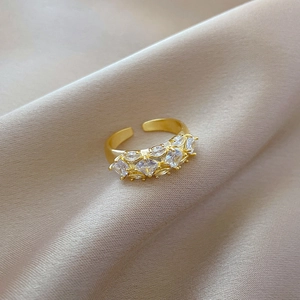 Gold plated adjustable ring with square cubic zirconia on champagne silk background