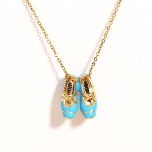 Detailed close-up of blue enamel ballet slipper pendant with gold straps and chain