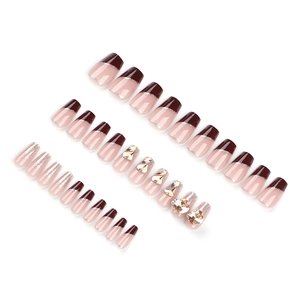 French red and champagne luxury press-on nails with glitter and rhinestones on white background