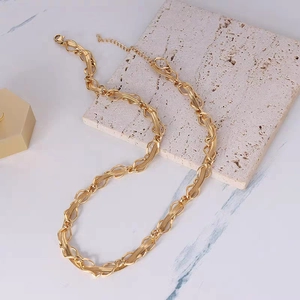 Minimalist gold-plated stainless steel snake chain necklace for women on stone background