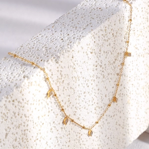 Detail of 18K gold plated stainless steel chain with diamond-shaped zircon pendants