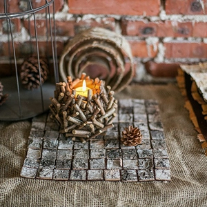 Rustic bird nest wooden candle holder on birch bark mat with warm lighting