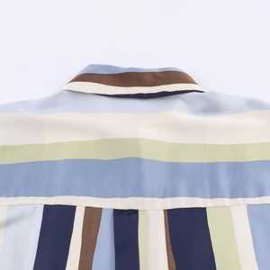 Detailed macro view of the striped satin shirt neckline and back shoulder fabric texture