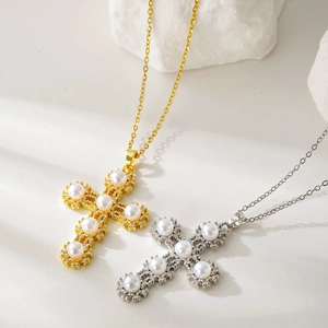 Detail of gold and silver cross necklaces with inlaid pearls and shimmering zircon stones