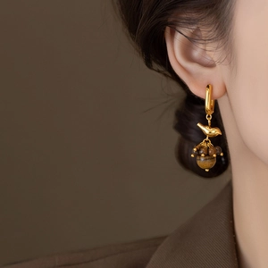 18k gold plated bird earrings with tiger eye beads and vintage tassel tassels on model