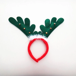 Detail of Christmas reindeer headband with red felt, green antlers and small golden bells