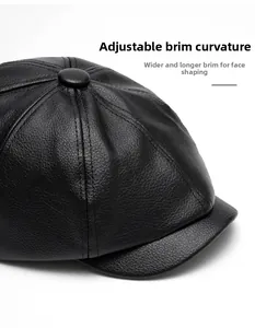 Detail of black pebbled leather newsboy cap with foldable brim and wide design