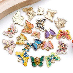 Flat lay of colorful alloy enamel butterfly charms for DIY jewelry making accessories