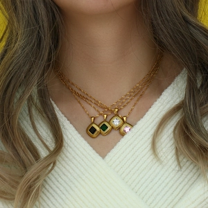 Close-up of vintage rhombic necklaces with multi-color zircon inlays on golden chains