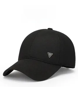 Detailed view of black wool baseball cap featuring a silver triangular metal logo accent
