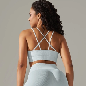 Detail of the light blue ribbed sports bra with criss-cross back straps and sleek texture