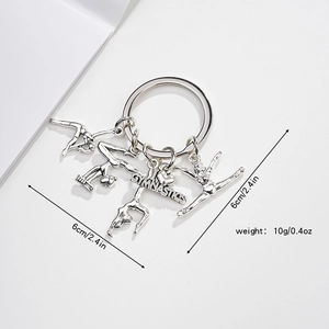 Gymnastics themed silver metal keychain with I love gymnastics charms and athlete poses