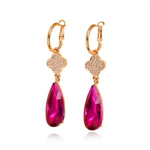 Vintage gold drop earrings featuring magenta teardrop gems and floral diamond accents