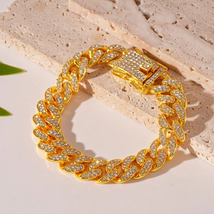 Close-up of golden Cuban link chain bracelet with micro-pave white zircons and box clasp