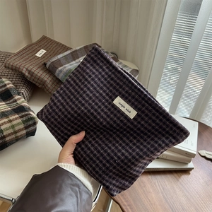 Detailed view of vintage plaid wool makeup bags with 'simple wish' label held in hand