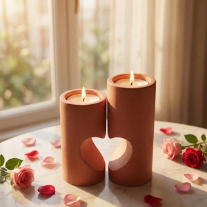 Terracotta heart-shaped resin mold candle holder set on marble table with rose petals