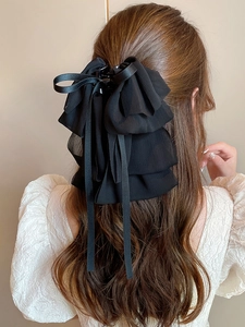 Elegant large black bow hair claw clip with long chiffon ribbons on model back view