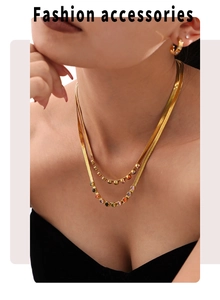 Detail of a 18k gold plated double layer necklace set with colorful zircon gemstones