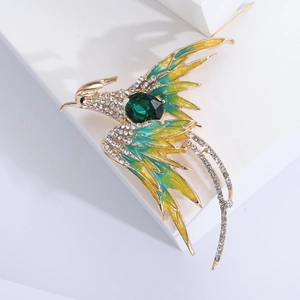 Detail of phoenix brooch with green enamel wings, gold alloy, and sparkling rhinestones