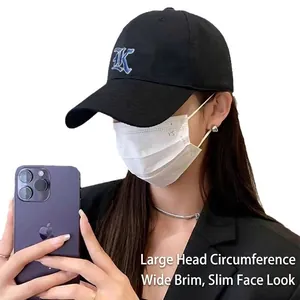 Black baseball cap with blue K embroidery and wide brim for sun protection and style