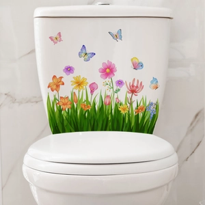 Detail of floral toilet wall stickers with green grass, colorful flowers and butterflies