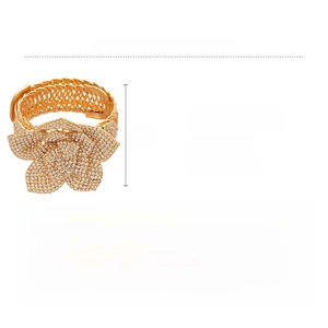 Detailed view of a gold floral cuff bracelet with rhinestones and size specifications