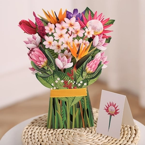 Detail of 3D pop-up greeting card featuring a colorful bouquet in a vase on a woven mat