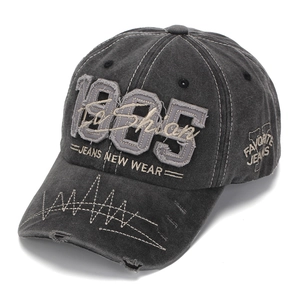 Close-up of vintage washed denim baseball cap with 3D embroidery and distressed brim