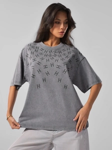 Detail of washed grey heavy cotton T-shirt featuring intricate rhinestone letter pattern