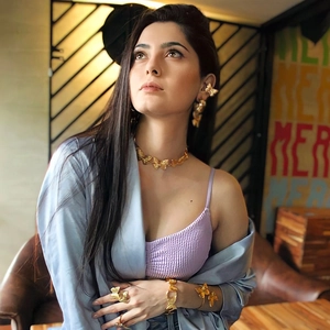 Detailed view of model wearing gold butterfly necklace, earrings, bracelet, and ring set