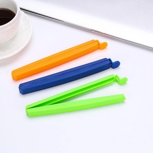 Three colorful plastic sealing clips for snacks and food bags shown on a white tabletop