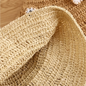 Macro shot of breathable natural woven fiber texture on beige summer straw bucket hat