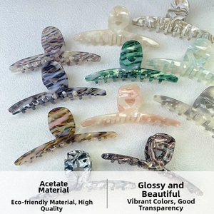 Macro detail of high-quality cellulose acetate shark hair claws in multiple marble patterns