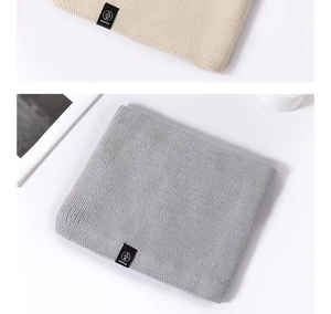 Close-up of winter knit neck warmer featuring a soft texture and a woven WINTER label