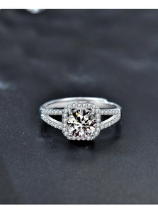 Close-up of 1 carat moissanite halo ring with 4-prong setting and pavé split shank band