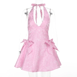 Detailed close-up of pink lace jacquard halter dress with cute side bow accents