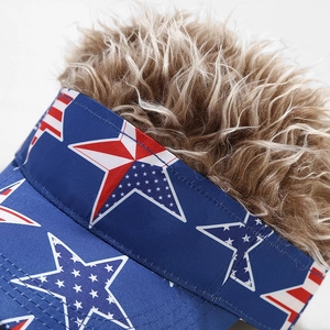 Detail view of American flag patterned sun visor hat with curly light brown wig hair