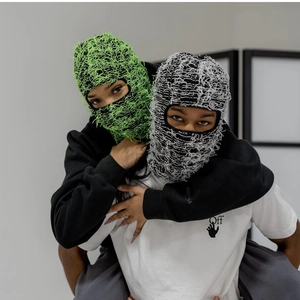 Distressed knit balaclava ski masks with fringe detail and camo punk style for adults