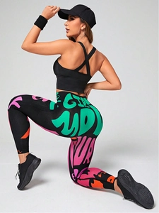 Close-up of high-waist yoga leggings featuring colorful graffiti print and seamless texture