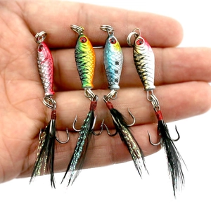 Detail view of 4 mini metal jig lures with scales, realistic eyes, and feathered treble hooks