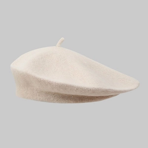 Classic knitted beret hat in elegant beige oatmeal color for winter fashion accessory