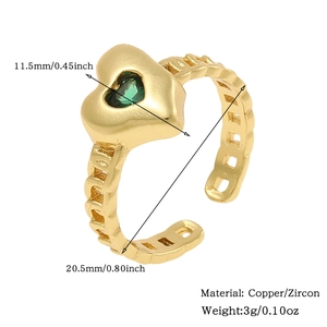 Detail view of a gold heart ring with green zircon and hollow chain design specifications